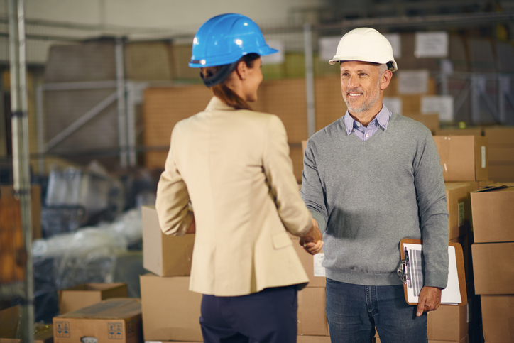 Rehabilitation consultant and worker shaking hands at the start of a workplace assessment